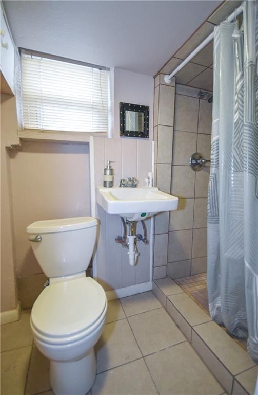 bathroom with sink, toilet, walk in shower, and tile patterned floors