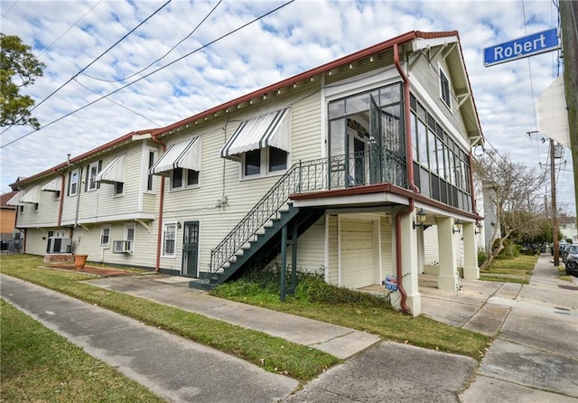 4937-39 S Miro St, New Orleans, LA 70125 - view of front of house featuring concrete driveway, stairs, cooling unit, and a garage