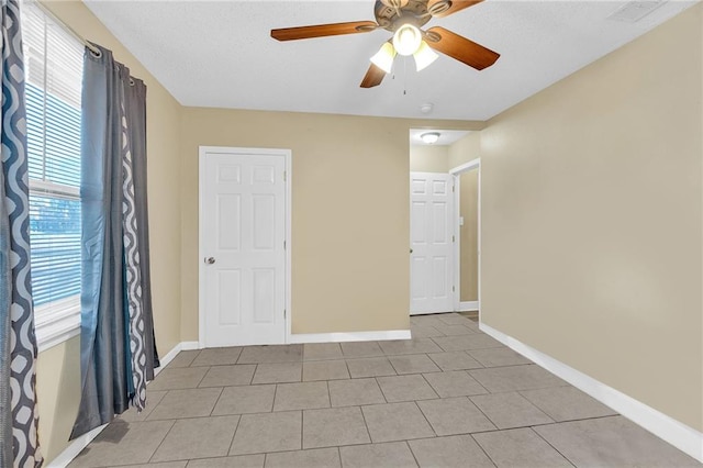 tiled empty room with ceiling fan