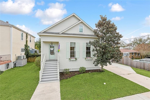 view of front of house featuring central AC unit and a front yard