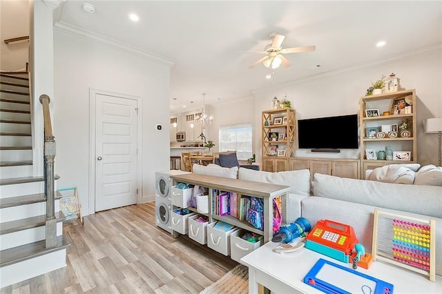 living room featuring ceiling fan, light hardwood / wood-style flooring, and crown molding