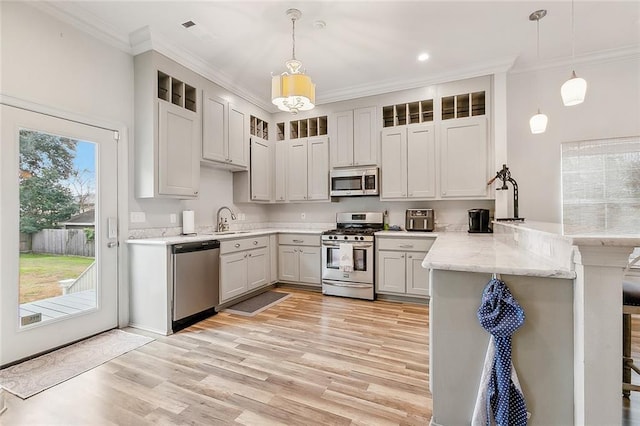 kitchen featuring sink, stainless steel appliances, kitchen peninsula, and pendant lighting