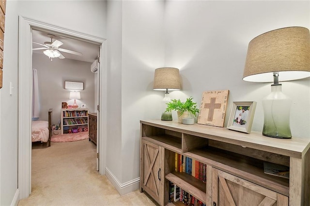 corridor with an AC wall unit and light colored carpet