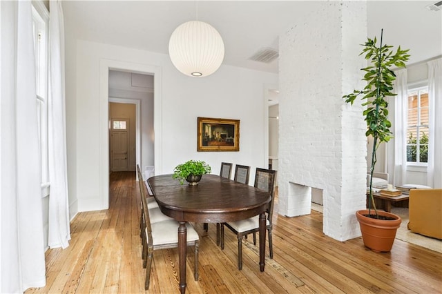 dining space with light hardwood / wood-style floors