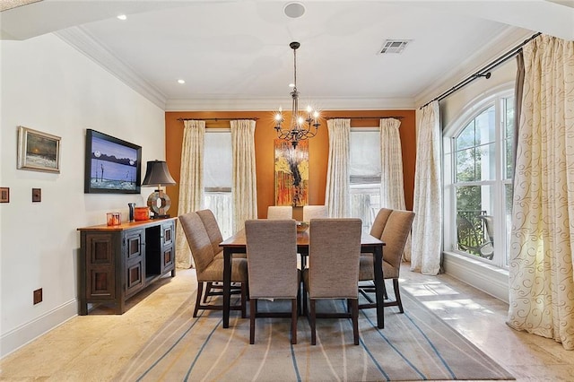 dining room featuring ornamental molding and a chandelier