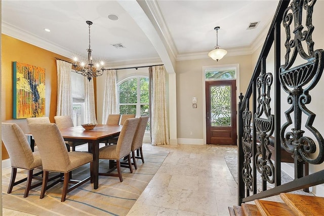 dining area featuring crown molding and a chandelier