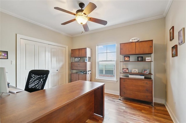 office space with dark wood-type flooring, ceiling fan, and crown molding