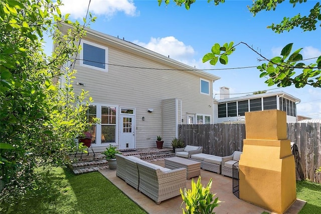 rear view of house with a yard, outdoor lounge area, and a patio area