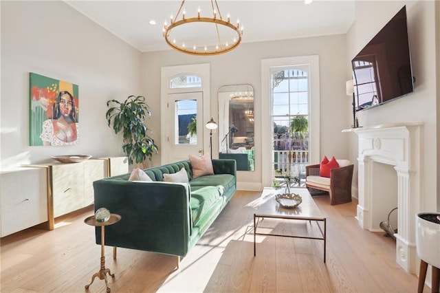 living room featuring a notable chandelier and light wood-type flooring