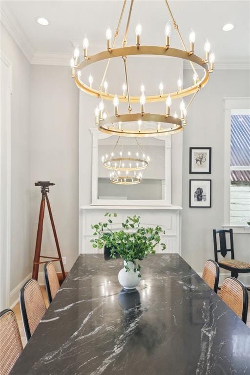 dining space with crown molding and a notable chandelier