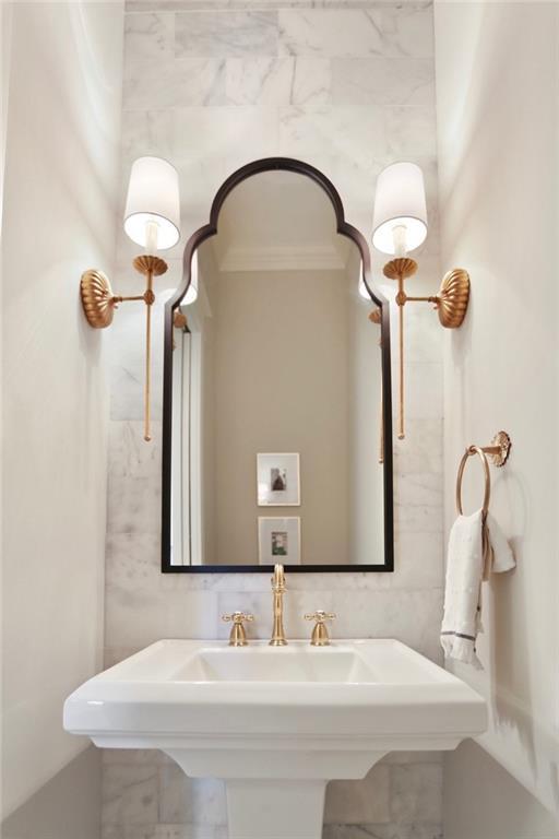 bathroom with ornamental molding and sink