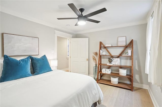 bedroom with crown molding, ceiling fan, and light hardwood / wood-style floors