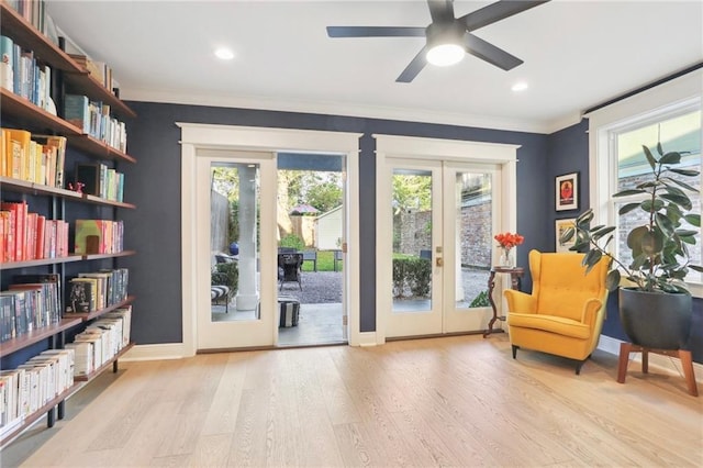 interior space with french doors, ceiling fan, ornamental molding, and light hardwood / wood-style floors