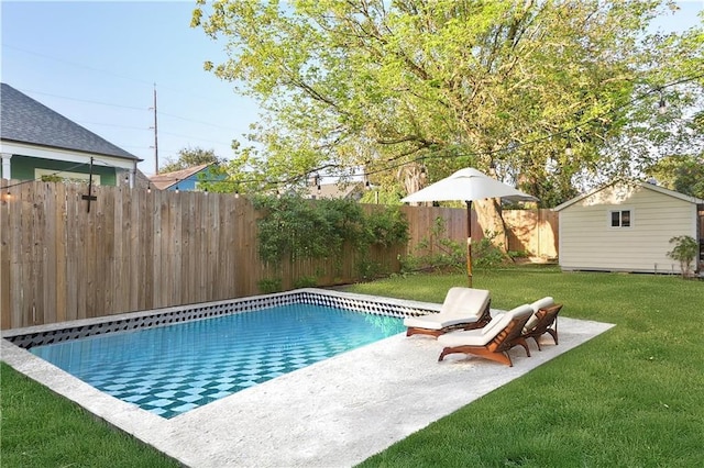 view of swimming pool with a lawn, a patio area, and a storage unit