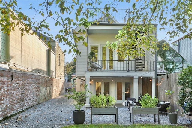 back of house with a patio, a balcony, and french doors