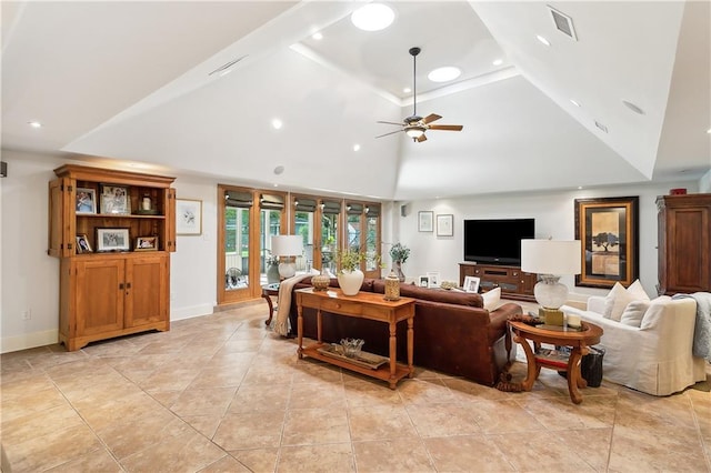 living room featuring ceiling fan, high vaulted ceiling, and a tray ceiling