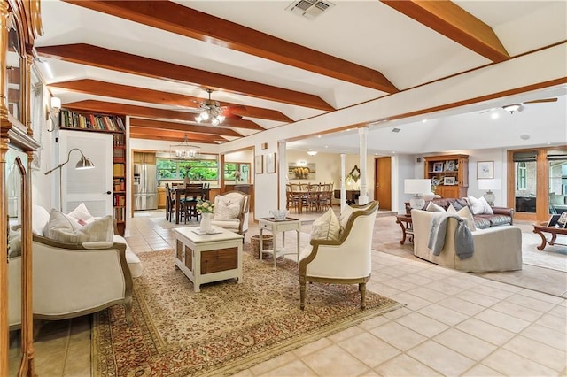 tiled living room featuring a chandelier and beamed ceiling