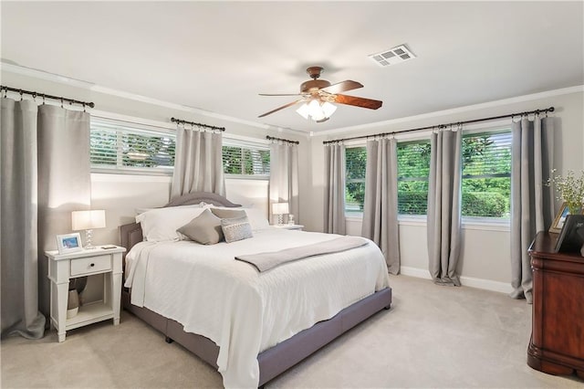 bedroom with ceiling fan, crown molding, and light carpet