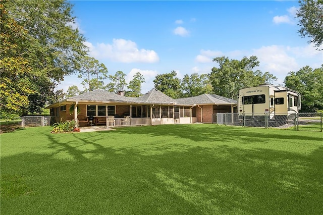 rear view of house with a yard