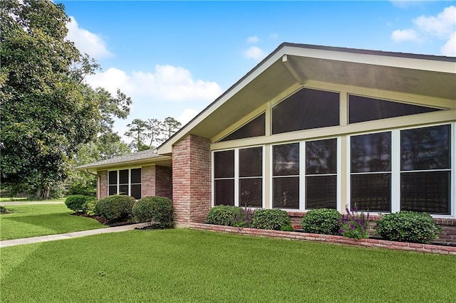 view of side of property featuring a yard