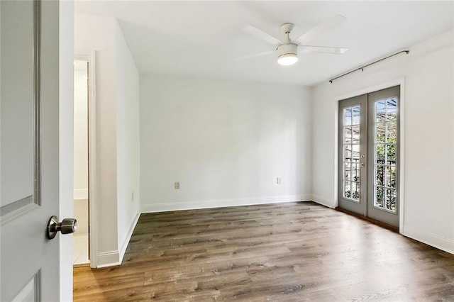 spare room featuring wood-type flooring, ceiling fan, and french doors