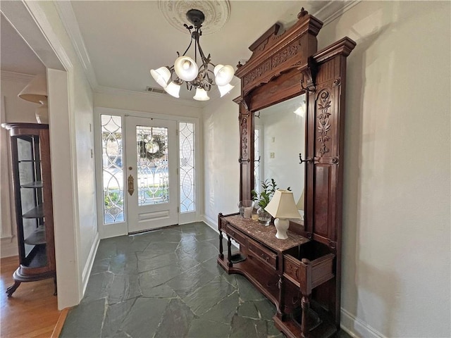 entrance foyer with an inviting chandelier and crown molding