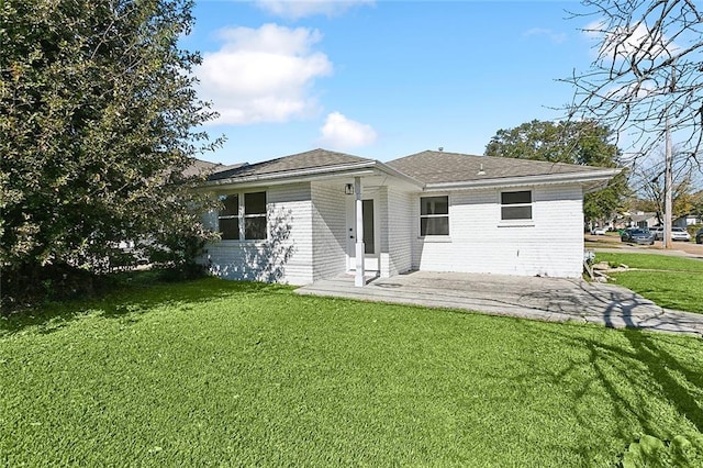 back of house featuring a patio and a lawn