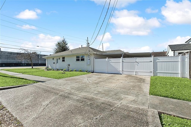 view of side of home with a yard