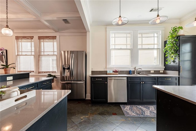 kitchen with sink, stainless steel appliances, a wealth of natural light, and decorative light fixtures