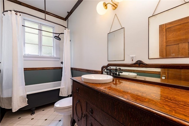 full bathroom featuring tile patterned floors, vanity, shower / tub combo, toilet, and crown molding