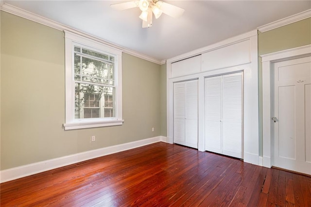 unfurnished bedroom featuring ceiling fan, ornamental molding, and dark wood-type flooring