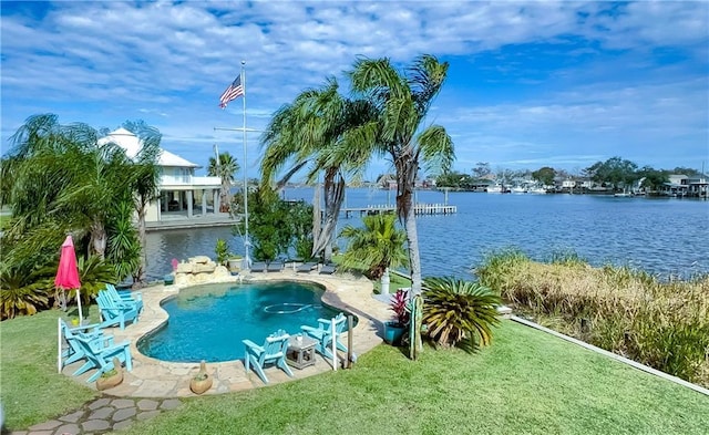 view of pool featuring a water view, a yard, and a patio