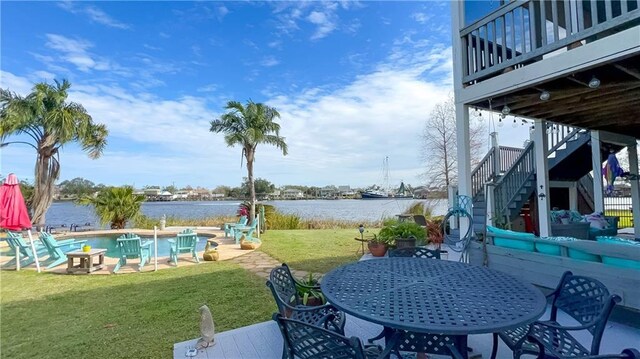 exterior space with a water view and a patio area