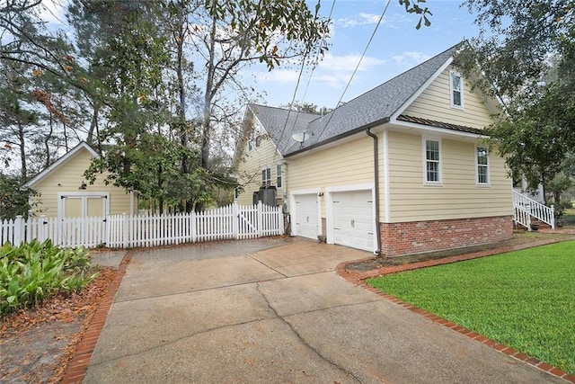 view of home's exterior with a garage and a yard