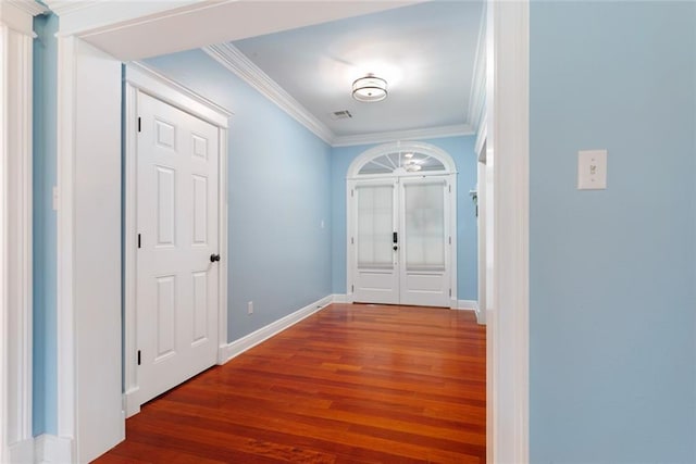 interior space featuring wood-type flooring, ornamental molding, and french doors