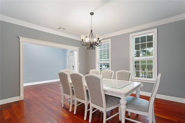 dining space featuring a notable chandelier, crown molding, and dark hardwood / wood-style floors