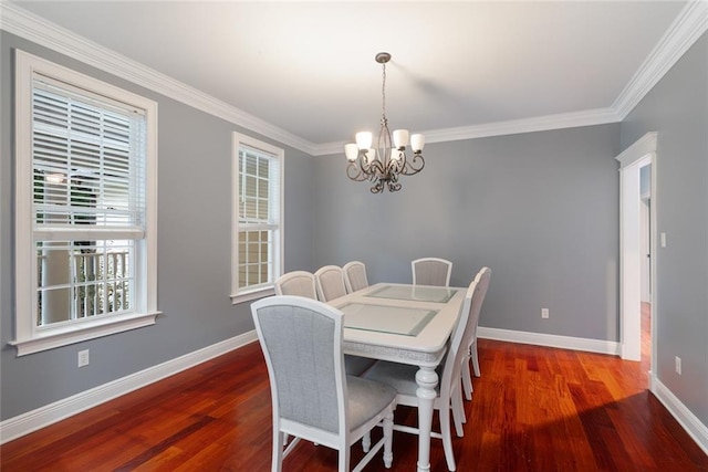 dining area featuring crown molding, a chandelier, and dark hardwood / wood-style floors