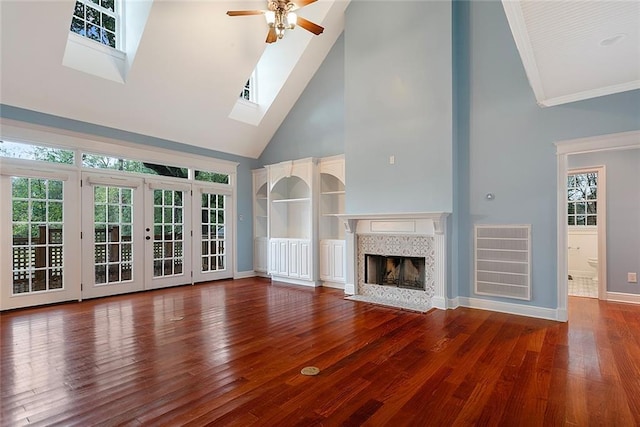 700 Dewey Ave, Slidell, LA 70458 - unfurnished living room with high vaulted ceiling, a ceiling fan, healthy amount of natural light, wood finished floors, and baseboards