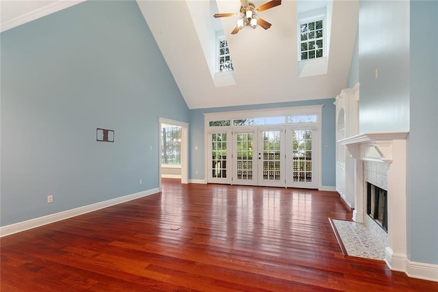 700 Dewey Ave, Slidell, LA 70458 - unfurnished living room with high vaulted ceiling, a ceiling fan, plenty of natural light, wood finished floors, and a high end fireplace