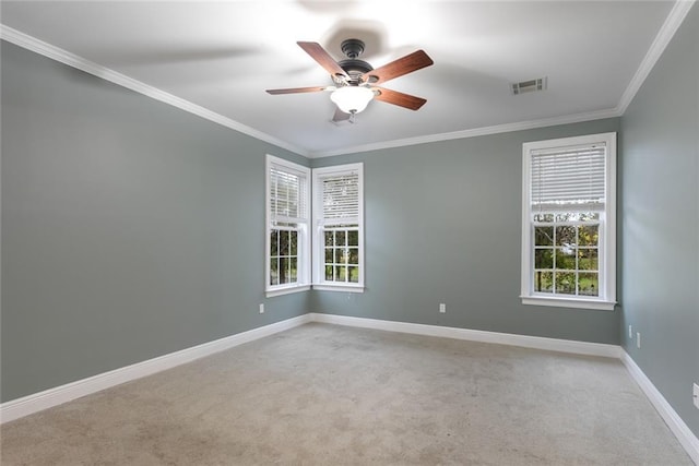 carpeted spare room featuring ceiling fan and crown molding