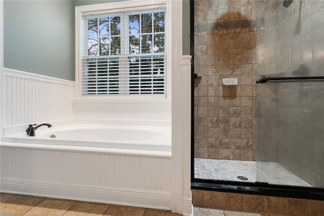 bathroom with separate shower and tub and tile patterned flooring