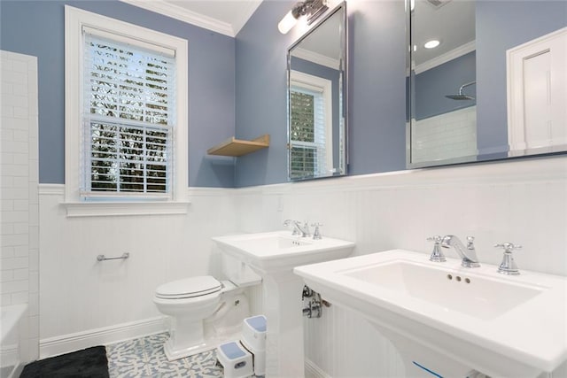 bathroom featuring shower / bathing tub combination, tile patterned floors, toilet, dual sinks, and crown molding