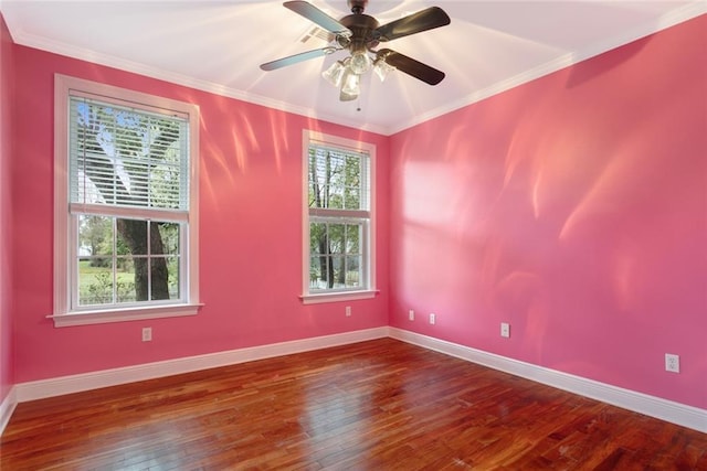 unfurnished room featuring wood-type flooring, ceiling fan, a wealth of natural light, and ornamental molding