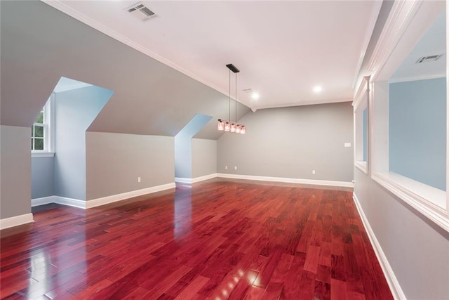 additional living space with dark wood-type flooring and lofted ceiling