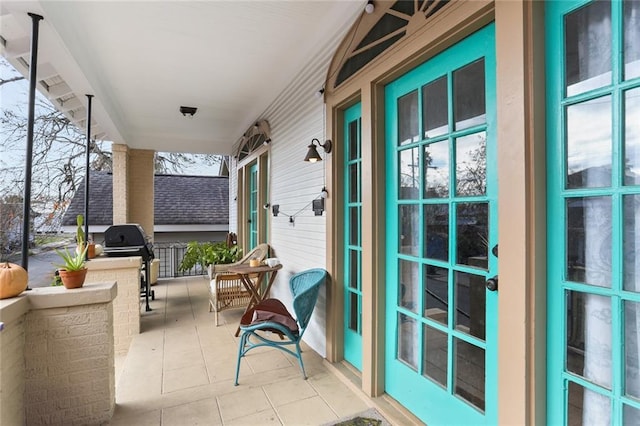 balcony with a porch and a grill