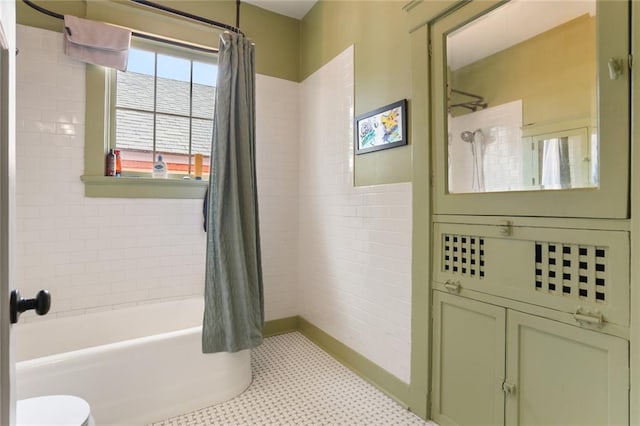 bathroom featuring toilet, tile patterned floors, and shower / bathtub combination with curtain