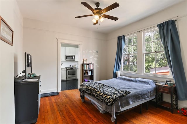 bedroom with ceiling fan and hardwood / wood-style floors