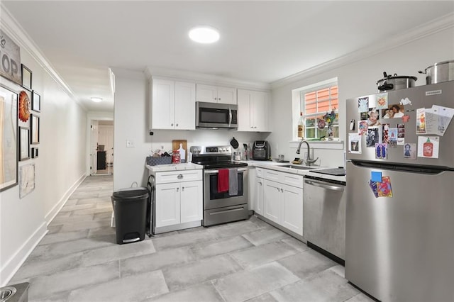 kitchen with sink, crown molding, white cabinetry, and stainless steel appliances