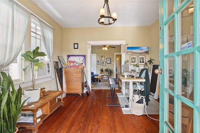 entrance foyer featuring ceiling fan with notable chandelier and dark hardwood / wood-style floors