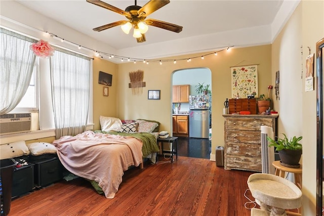 bedroom featuring ceiling fan, cooling unit, and dark hardwood / wood-style floors